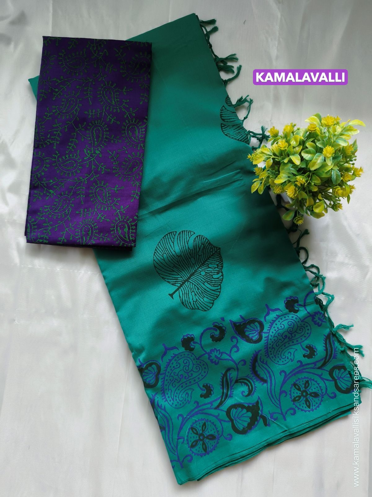 Teal saree with patterns and purple blouse fabric, featuring 'Kamalavalli' branding.